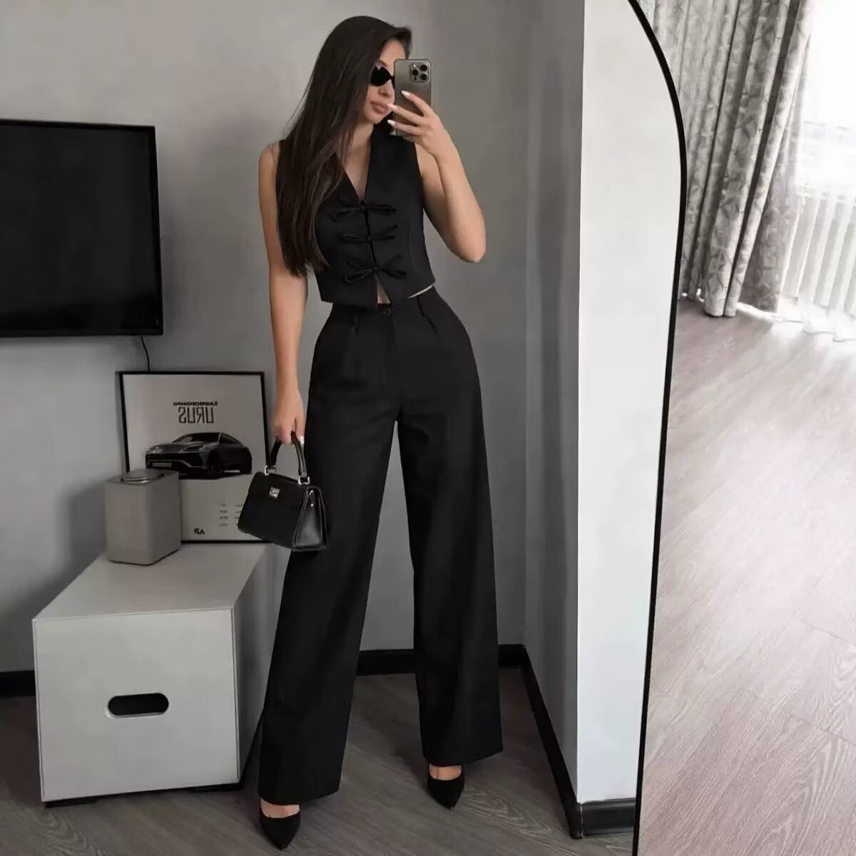 Black bow-tie vest and wide-leg trousers set - full outfit styled with heels