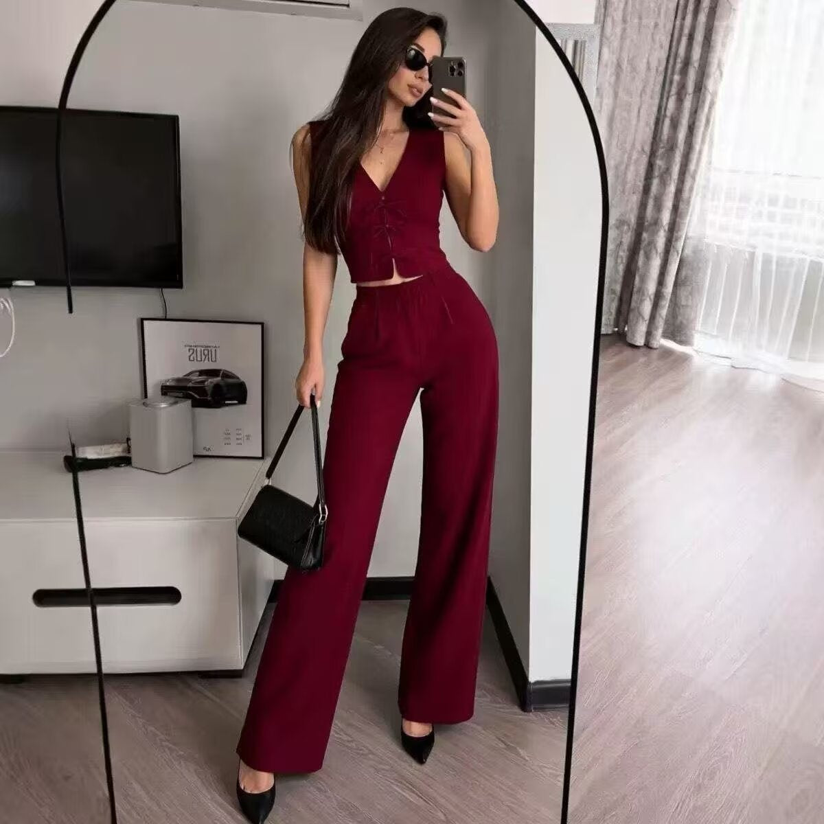Wine red high-waisted wide-leg trousers - full length front view styled with black top