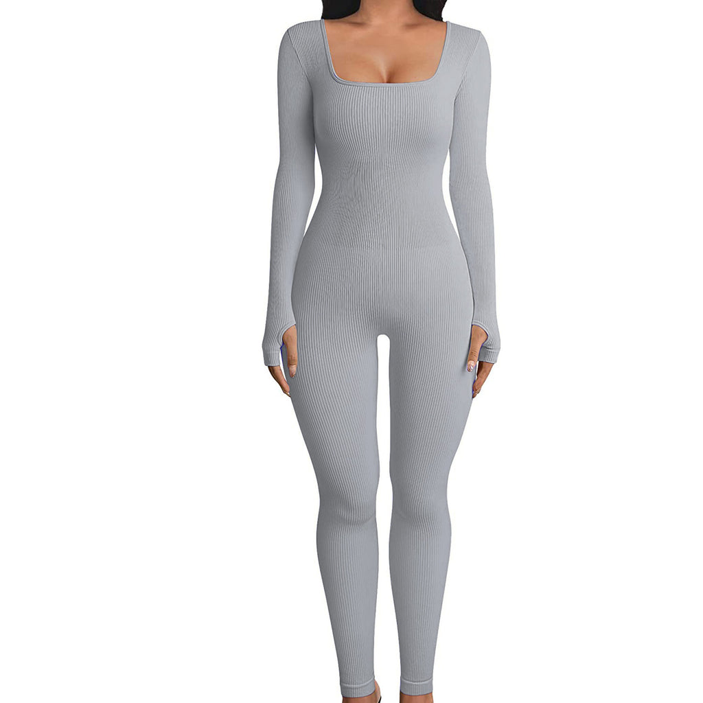 A woman modeling a light gray ribbed long-sleeve one-piece jumpsuit with a square neckline against a plain white background.