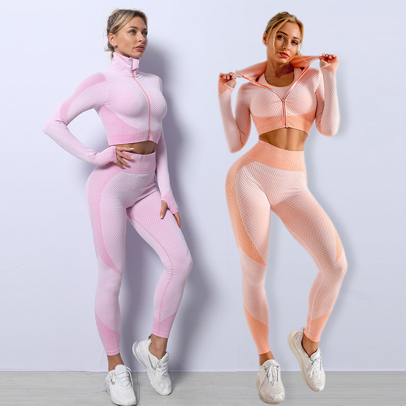 Two women wearing pink and peach athletic outfits against a light gray background