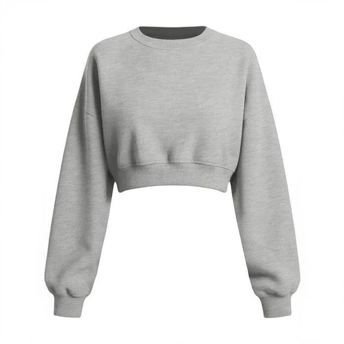 A light gray heather cropped crewneck sweatshirt with long sleeves and ribbed cuffs, displayed on a solid white background.