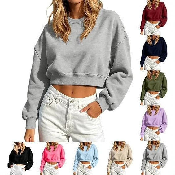 A woman models a light gray cropped crewneck sweatshirt with long puff sleeves and white jeans. Eight smaller color variants are shown along the right side against a plain white background.
